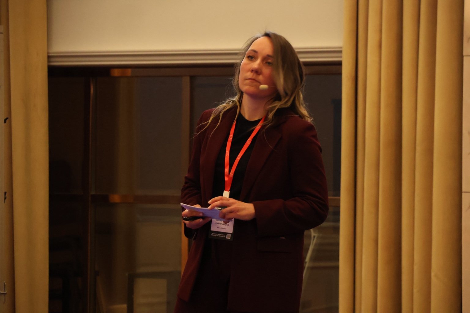 Close-up portrait of Janine Bubner speaking on stage
